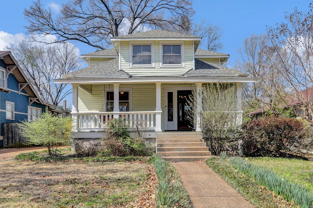 The front of the house, straight on, in early spring.